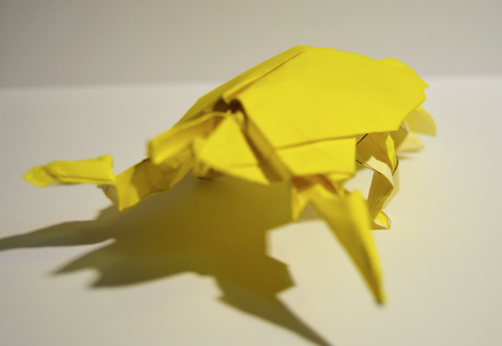 Yellow origami bug side view